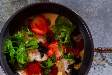 Salad with eel, strawberries, chuka, two-color tobiko caviar