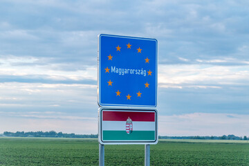 Entrance Hungary (Magyarorszag) border sign and flag of Hungary on the Austria - Hungary border.