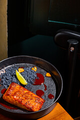 Grilled salmon steak with lemon, blue salt and sauce