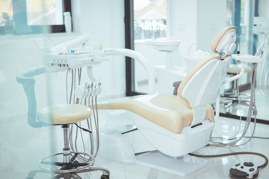 Modern dental practice. Dental chair and other accessories used by dentists. Dentist Office, Dental Hygiene, Dentist's Chair. dentistry, medicine, medical equipment and stomatology concept