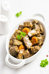 Beef carrot spiced liver in ceramic dish. Copy space.