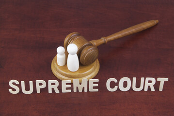 Supreme court decision about abortion concept. Letters supreme court with judge gavel and people...