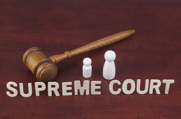 Supreme court decision about abortion concept. Letters supreme court with judge gavel and people...