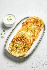 Healthy squash pancakes with sour cream sauce. Top view, copy space, flat lay.