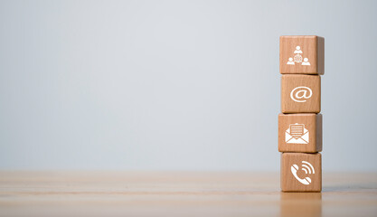contact us icon phone, email, mail on wood cube, Website page contact us or e-mail marketing concept