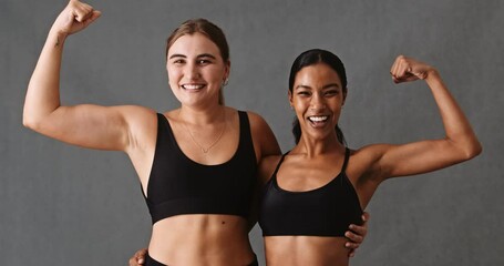 Two friends flexing their arm muscles after gym