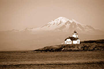 Light house in front of mountain in Washington State in sepia.