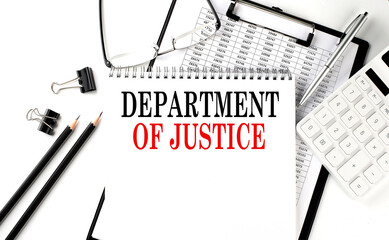 DOJ - Department of Justice word on notepad with clipboard , chart and calculator, business concept - obrazy, fototapety, plakaty