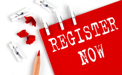 REGISTER NOW text on red paper with office tools on white background