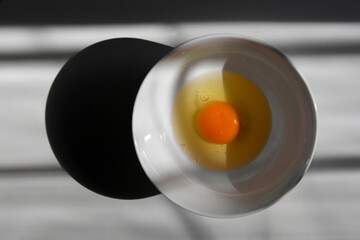 Fresh raw egg in a white bowl