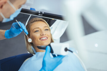 Overview of dental caries prevention.Woman at the dentist's chair during a dental procedure. Beautiful Woman smile close up. Healthy Smile. Beautiful Female Smile