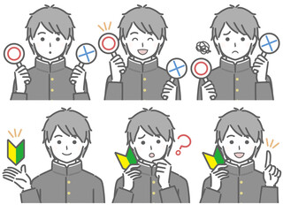 〇✕マークや初心者マークを持つ男子学生