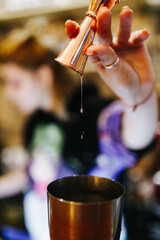 the bartender prepares a cocktail at the bar