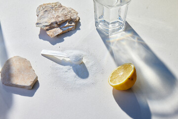 Sport food supplement powder with natural beige background and props. Still life: supplement, creatine, hmb, bcaa, amino acid or vitamine in a white scoop. Sport nutrition and healthy life concept