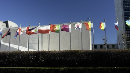 Flags flying in wind. Russian, Romanian Poland flag flying at UN headquarter in NYC