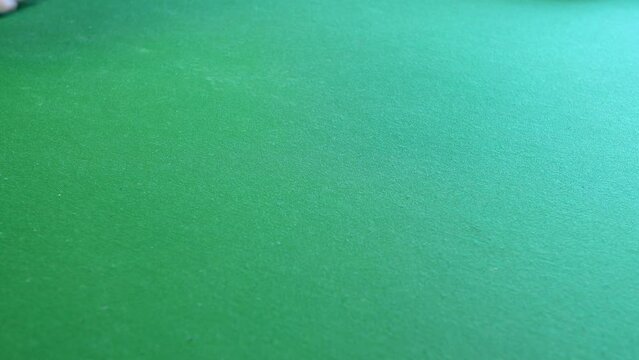 Rolling double one snake eyes with dice on craps table in casino