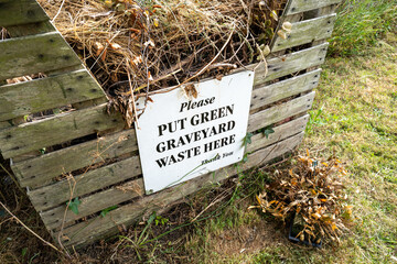 Generic green waste sign seen on a wooden collection crate used for visitors to discard dead...
