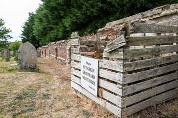 Generic green waste sign seen on a wooden collection crate used for visitors to discard dead...