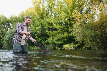 trout being caught in fishing net.