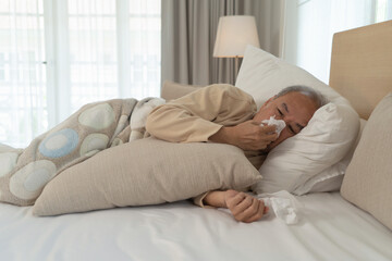 Old elderly senior man. Sick Asian person coughing in medical treatment and health care on bed in...