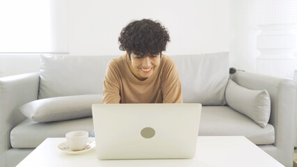 Portrait of business Asian woman, person working online at home or house, drinking a cup of coffee, using a computer laptop notebook, technology device. People lifestyle.