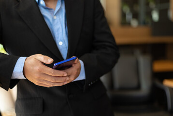 Close up of business people using mobile phones in the office.