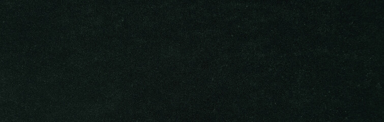 Textured green paper background texture. Dark green velvet.