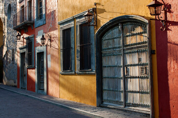 Exterior view of colorful historical buildings in the old town neighborhood of San Miguel de...