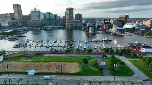 Aerial truck shot of Baltimore Inner Harbor from Federal Hill. Marina and boats at golden hour.