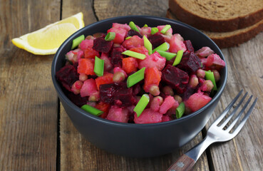 Vinaigrette traditional russian salad with boiled vegetables on wooden background. Selective focus
