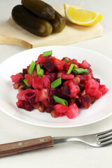 Vinaigrette traditional russian salad with boiled vegetables on concrete grey background. Selective focus
