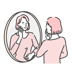 鏡を見て笑顔の女性
