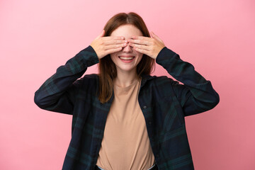 Young English woman isolated on pink background covering eyes by hands and smiling