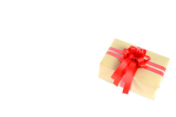 Brown craft gift box with red ribbon bow isolated on white background.	