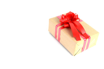 Brown craft gift box with red ribbon bow isolated on white background.	