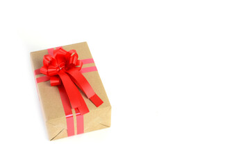 Brown craft gift box with red ribbon bow isolated on white background.	