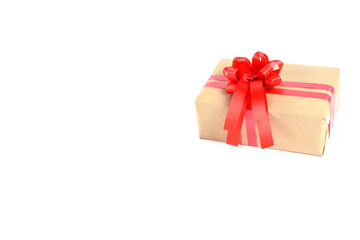 Brown craft gift box with red ribbon bow isolated on white background.	
