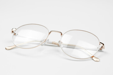 Fototapeta na wymiar Stylish eyeglasses on a white background. Iron frame glasses