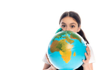 Schoolkid holding globe near face and looking at camera isolated on white.