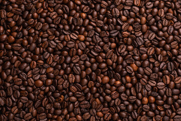 Roasted coffee beans. Top view brown coffee beans texture for backdrop and wallpaper