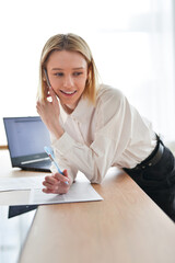 Woman at work talking on the phone smiling