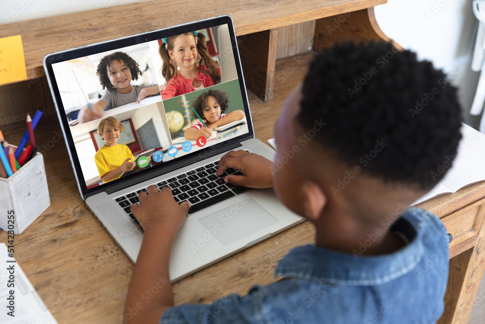 Poster African american boy looking at laptop screen with multiracial students during online class