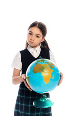 Serious schoolchild holding globe and looking at camera isolated on white.