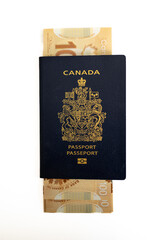 Calgary, Alberta - June 29, 2022: Canadian passport with Canadian 100 dollar bills.