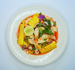 Spicy squids roe with corn thai salad style decoration vegetable and chili.. Top view