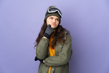Teenager Russian girl with snowboarding glasses isolated on purple background having doubts while looking up