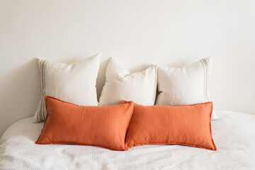 Linen pillows on a white bed. Comfortable bed with pillows in room. Modern home decor. Interior design. Template.
