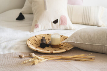 Linen pillows on a white bed with home decor. Still life details in home on a bed. Cozy home. Sweet home