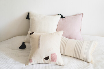 Linen pillows on a white bed. Comfortable bed with pillows in room. Modern home decor. Interior design. Template.