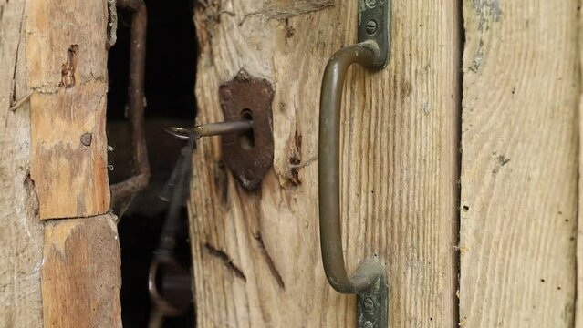 The old door is opened. Old lock and keys
